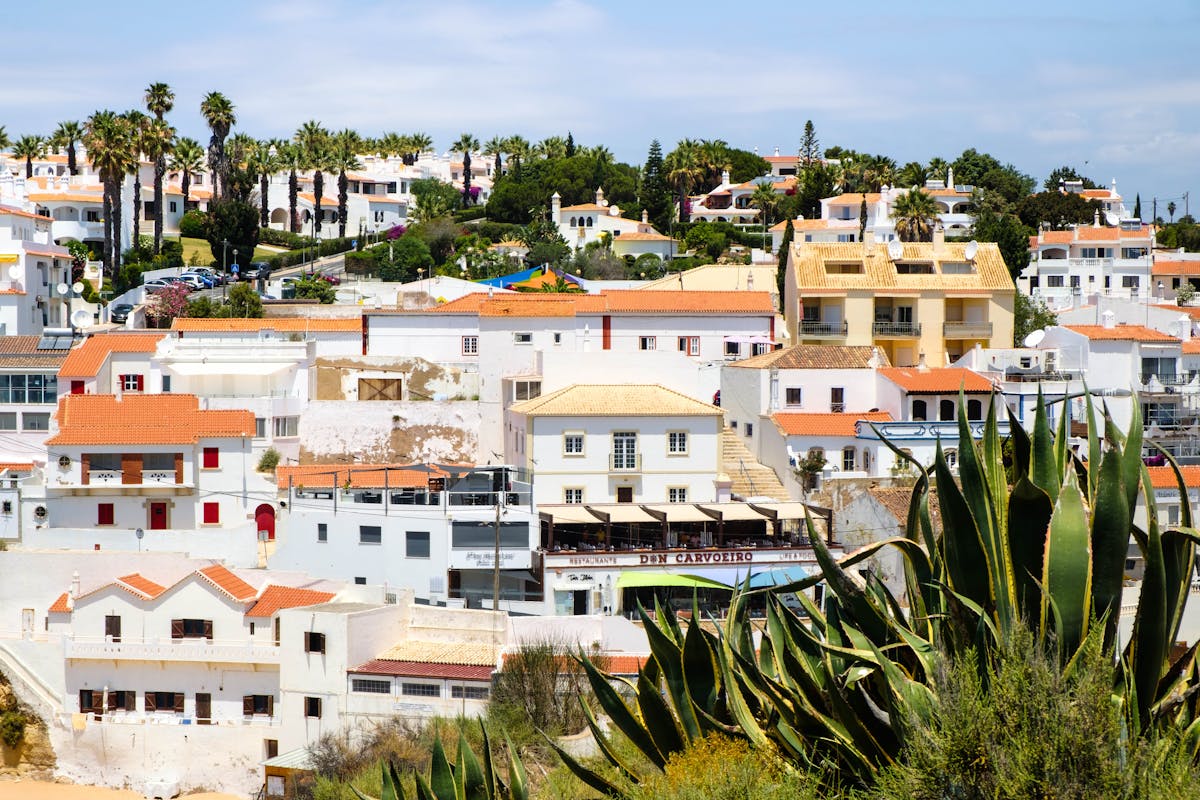 Whitewashed houses with terracotta roofs in the Algarve town of Carvoeiro