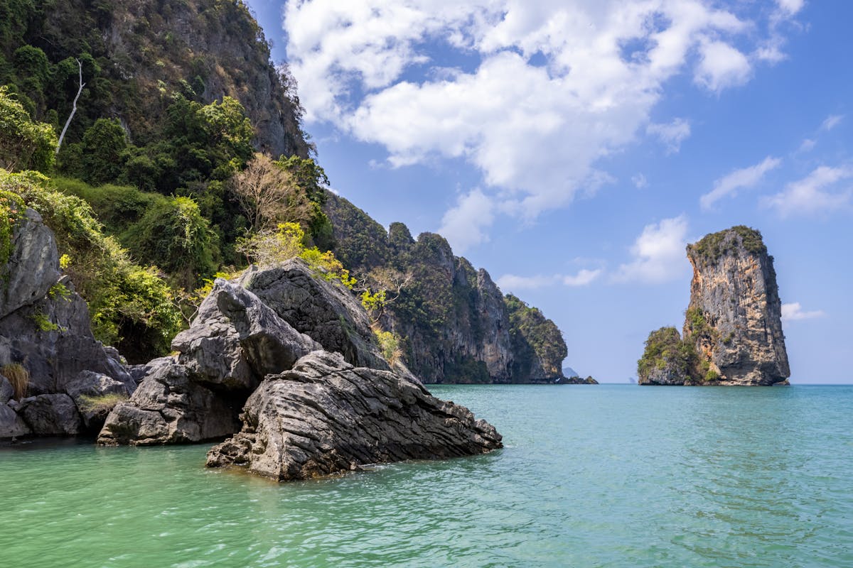 Rock formations and limestone cliffs above the turquoise water of Ao Nang Beach in Krabi, Thailand