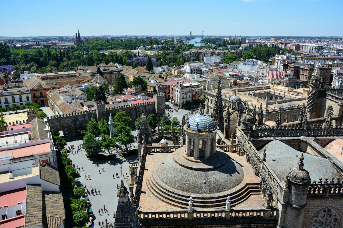 Aerial view of Seville Cathedral and the Giralda tower over the city rooftops