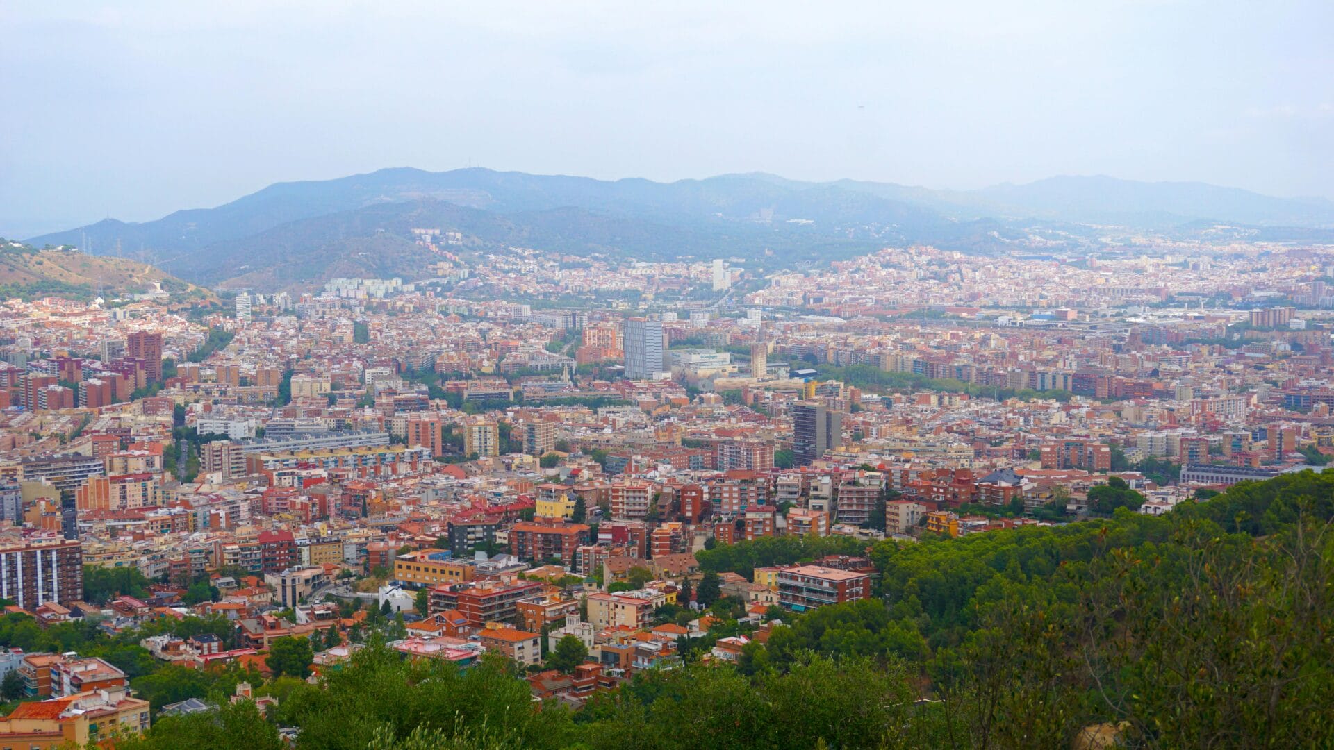 Aerial view of Barcelona with Sagrada Família visible among the city grid