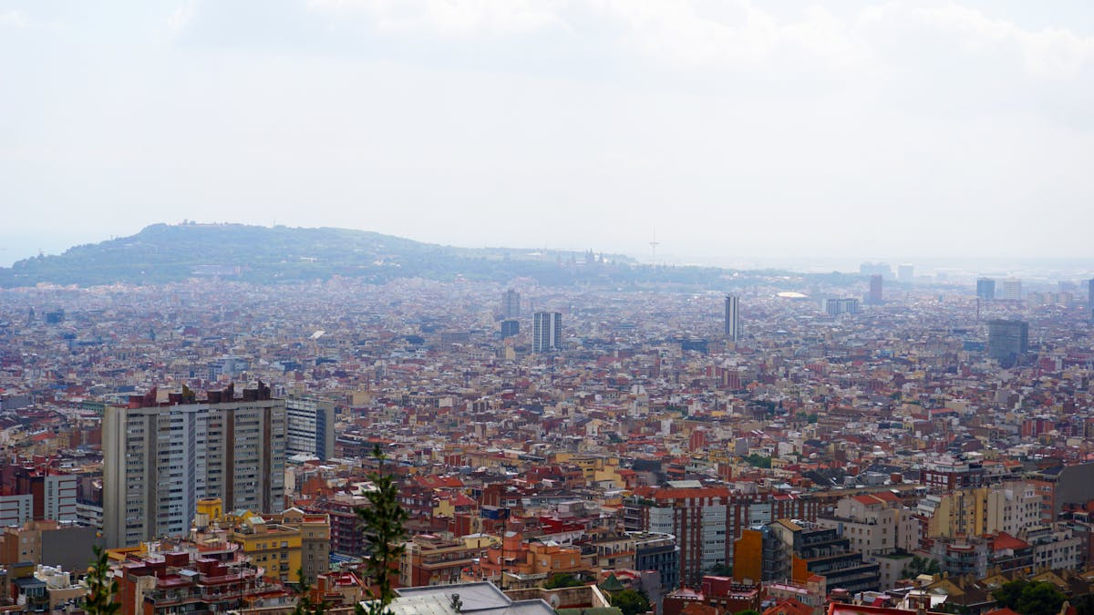 Aerial view of central Barcelona showing the Eixample grid district and the city stretching to the sea, Catalonia, Spain