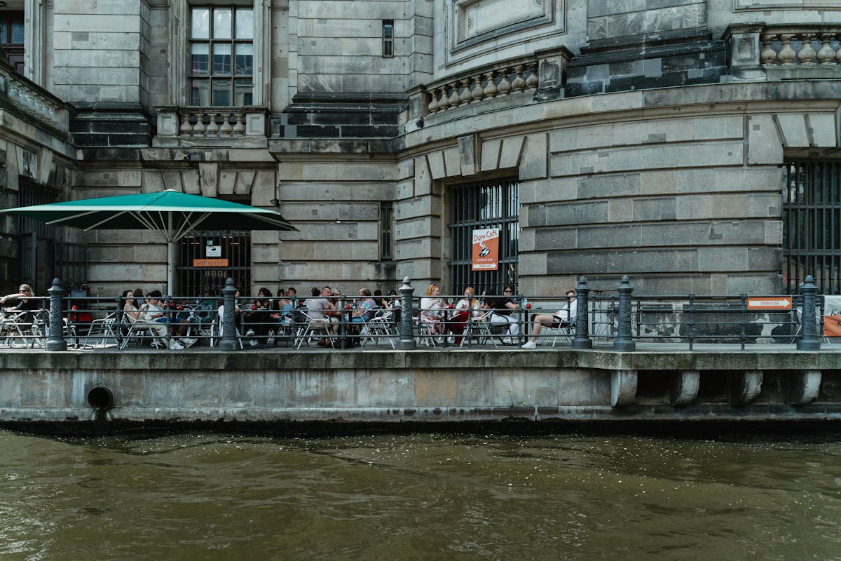People sitting at an outdoor café on the Spree riverside by the Berliner Dom in central Berlin