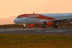 easyJet aircraft on the runway at sunset, ready for departure