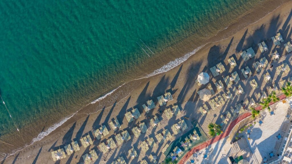 Aerial view of Bodrum beach with sun umbrellas and clear water