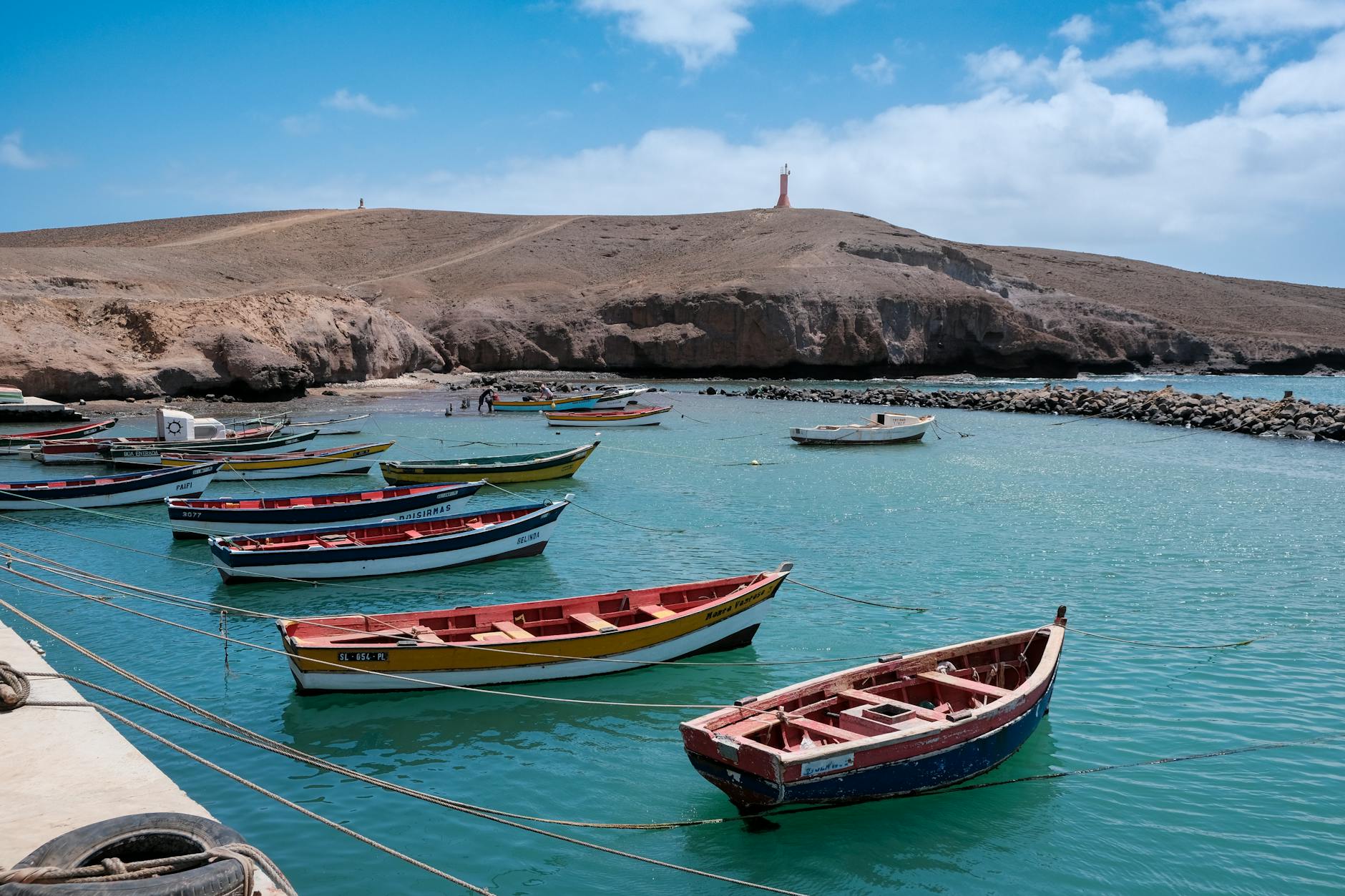 Colourful fishing boats anchored in the serene waters of Sal, Cape Verde