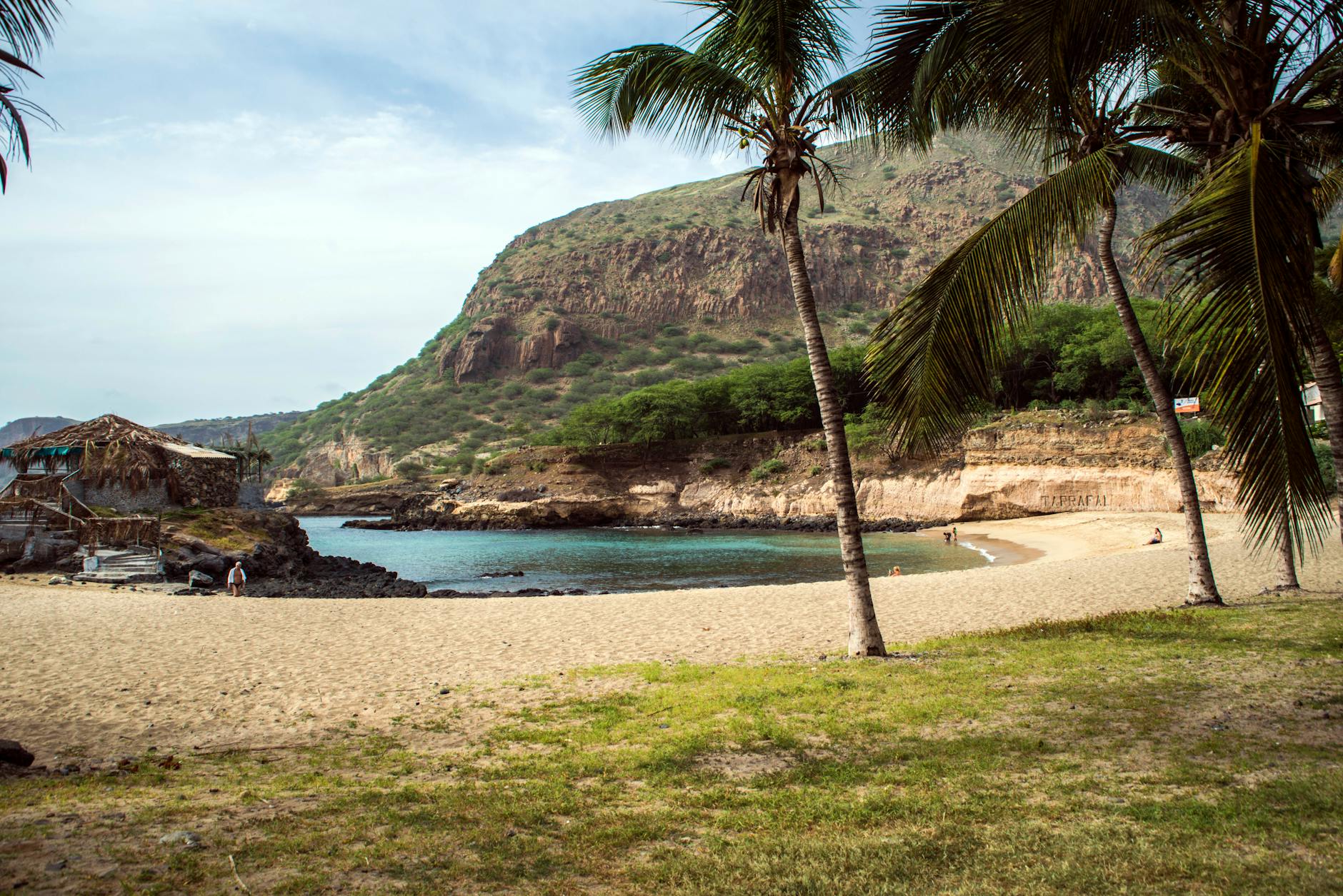 Tranquil tropical beach in Cape Verde with clear waters and palm trees