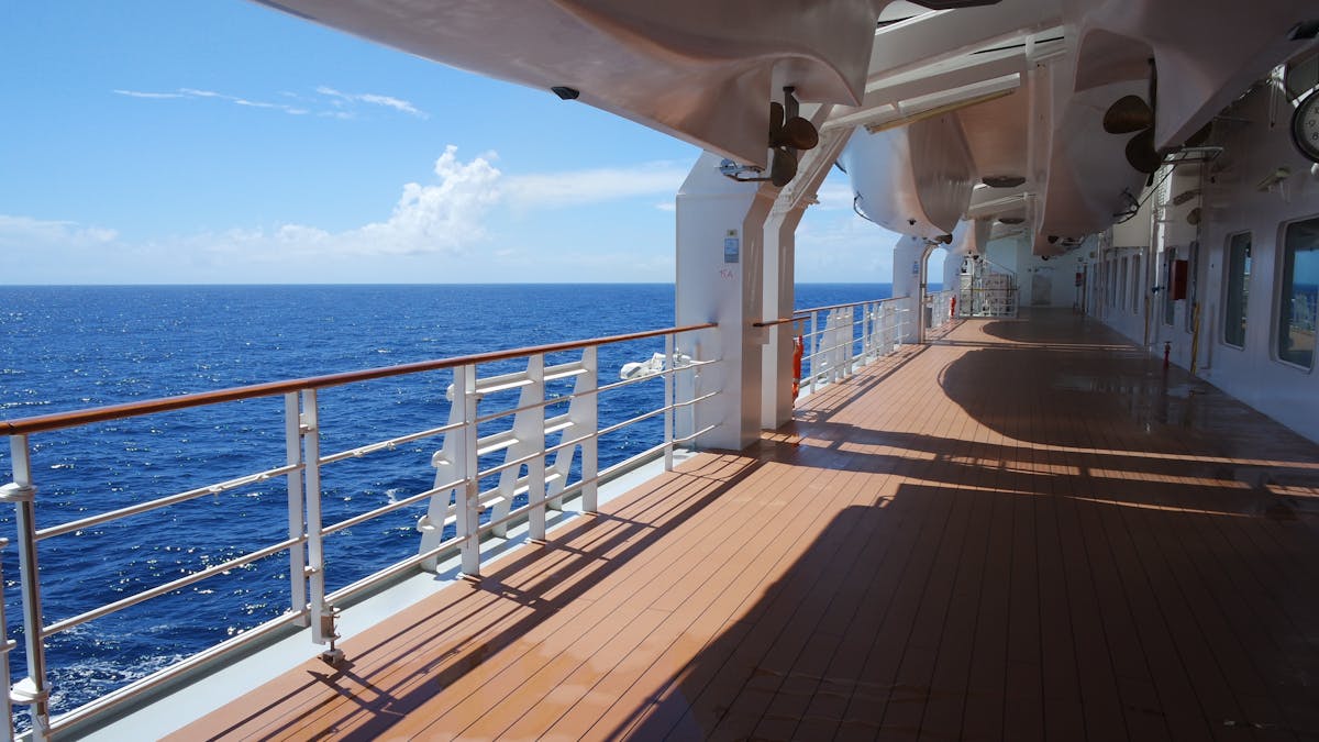 Cruise ship deck with sun loungers overlooking the open ocean
