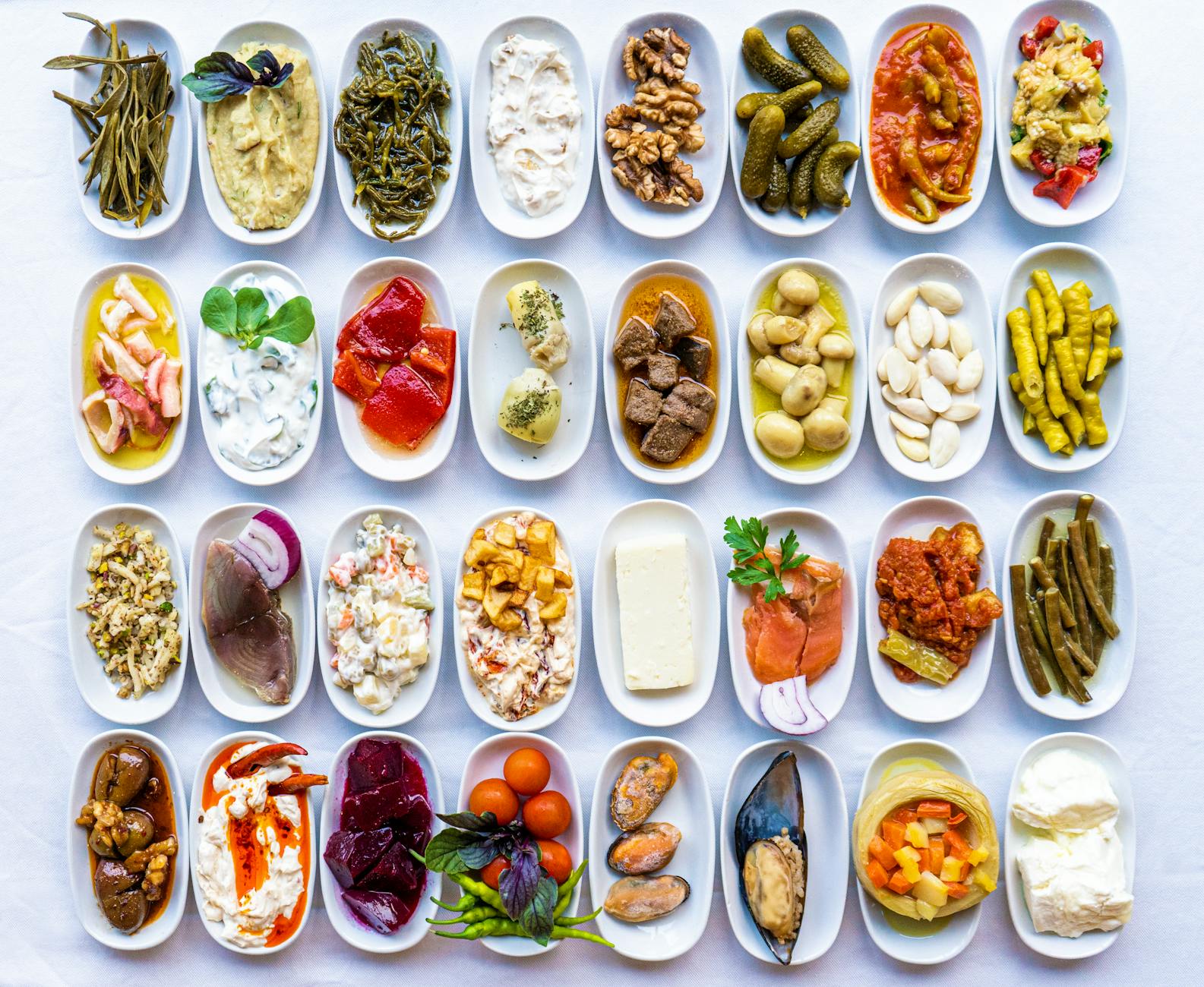 Turkish meze spread — olives, hummus, and salads on a wooden table