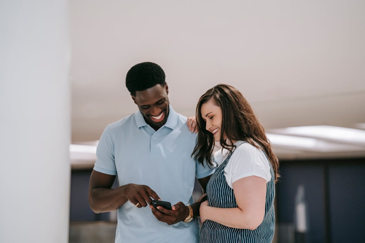 Couple checking flight prices on phone