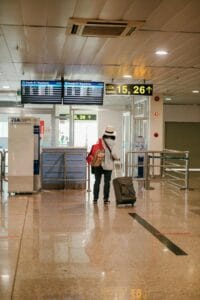 Woman at airport checking easyJet flight deals on phone