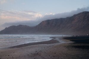 Famara Beach in Lanzarote with volcanic cliffs