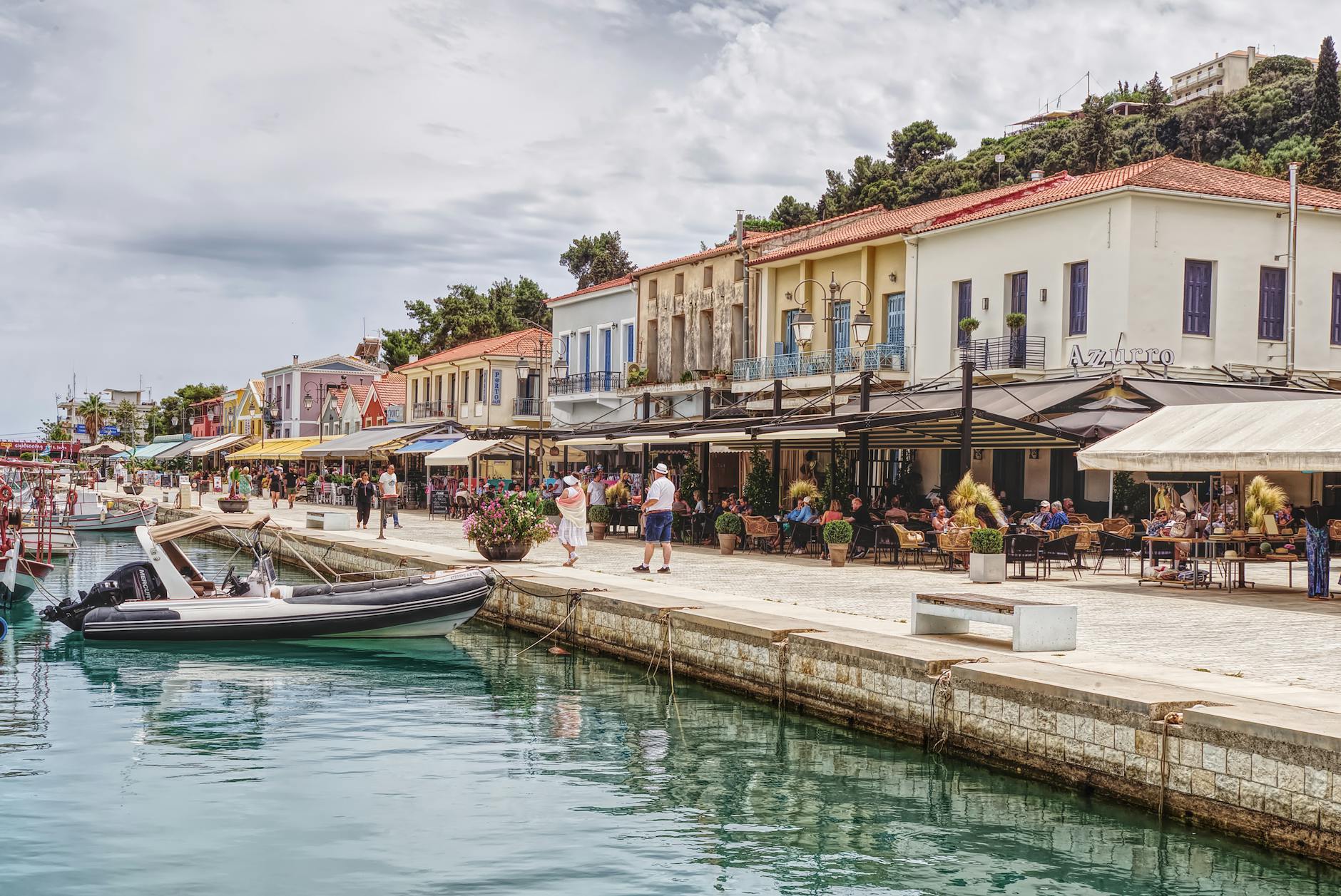 Scenic harbour front with waterfront restaurants and boats in Fiskardo, Greece