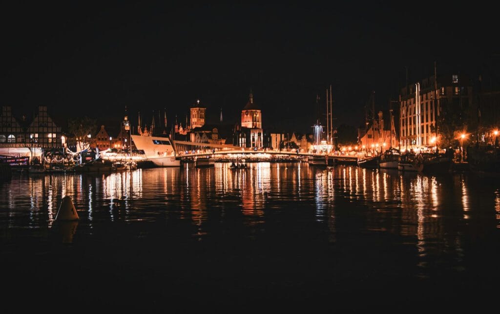 Gdansk Old Town at night with coloured lights reflecting on the Motlawa River