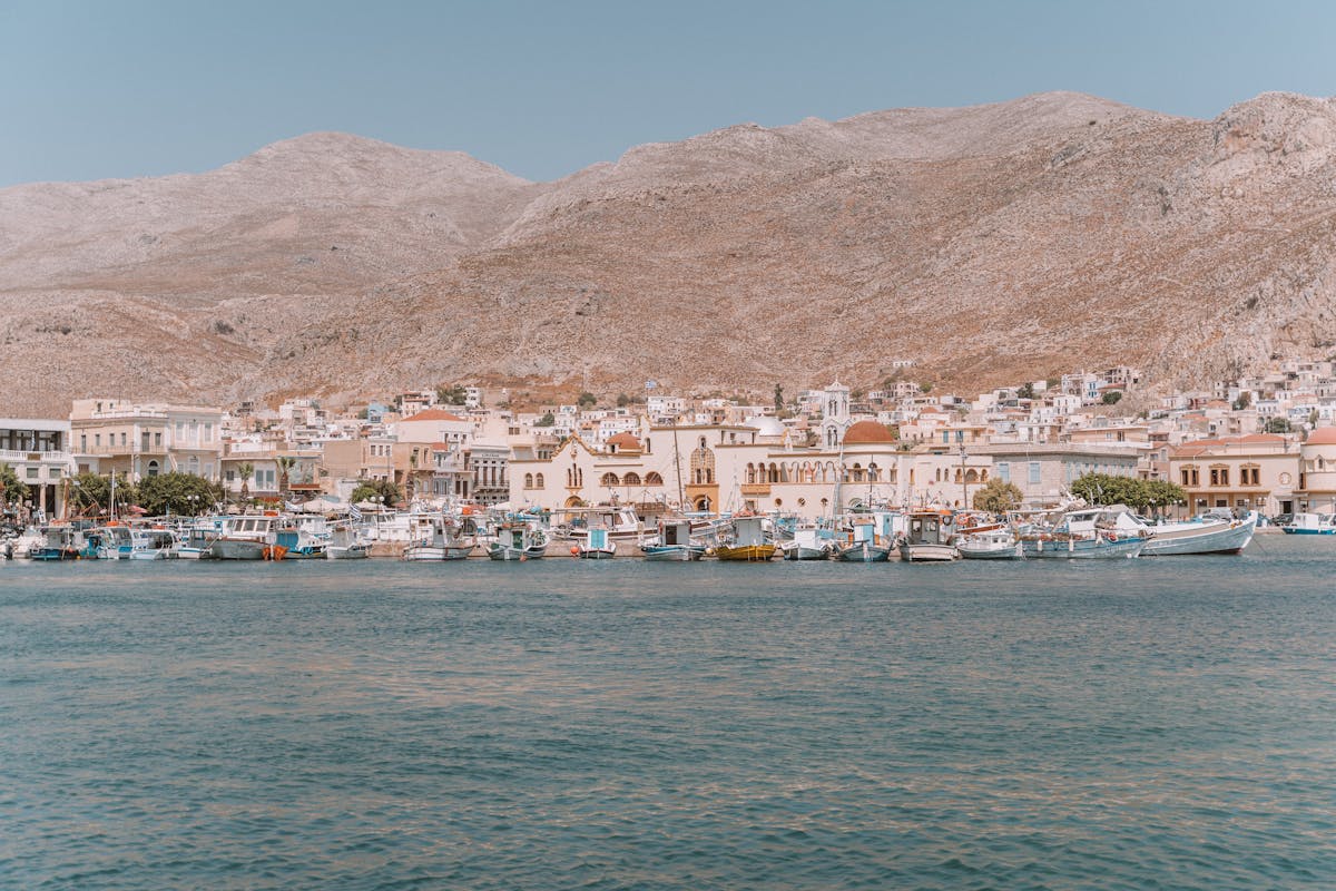 Colourful fishing boats moored in a harbour in a Greek island village