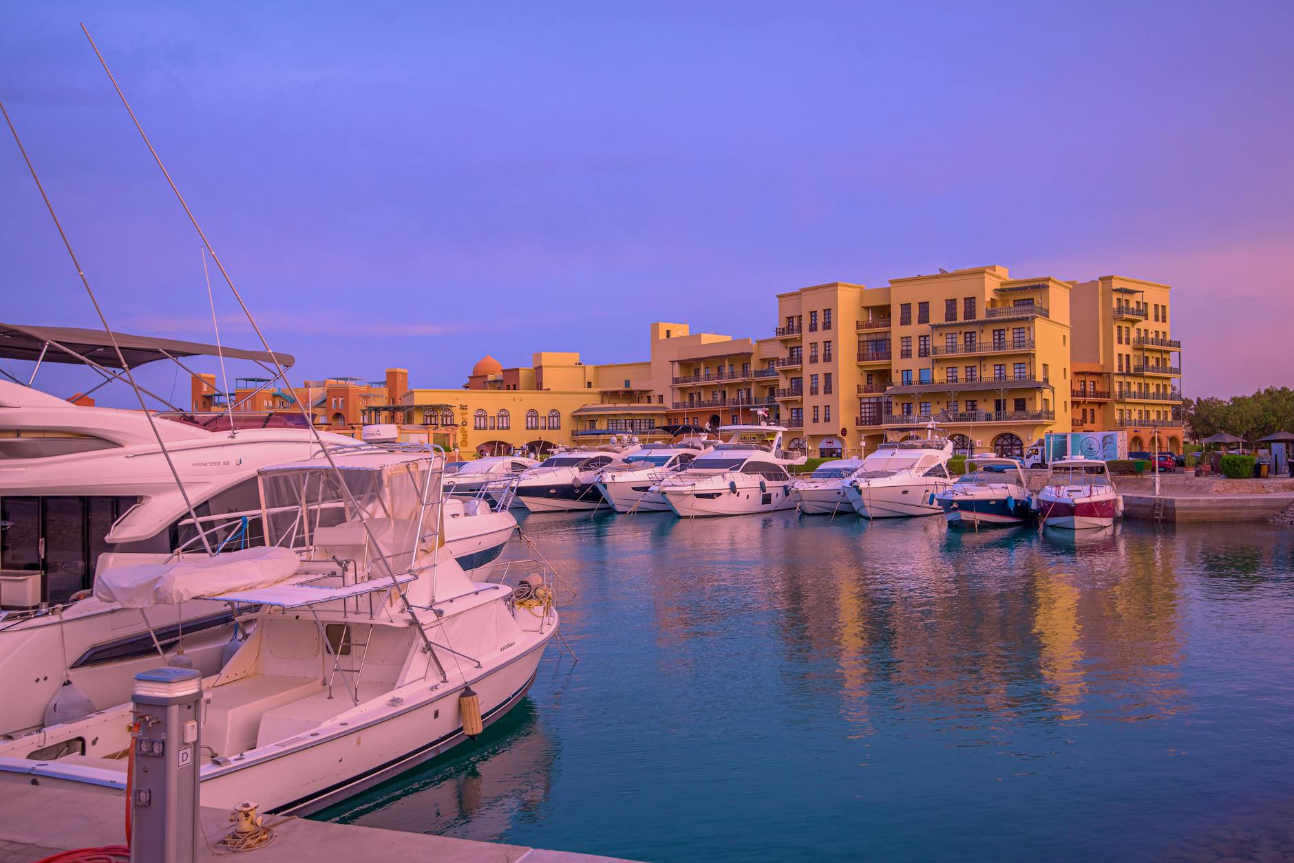 Hurghada Marina at sunset with moored boats and waterfront restaurants