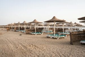 Hurghada beach with straw umbrellas and sunbeds on the Red Sea coast