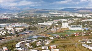 Aerial view of Reykjavik city with mountains and harbour in the background, Iceland
