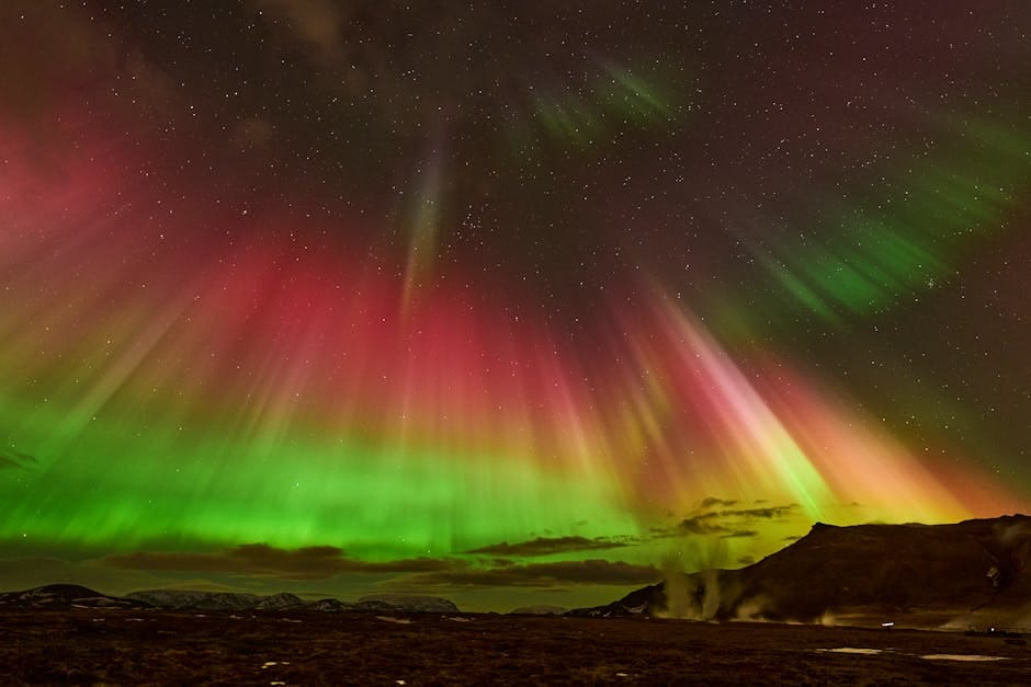 Aurora borealis dancing over a snow-covered landscape in Iceland