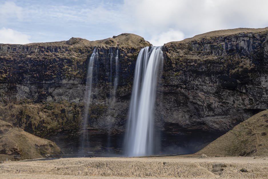 Seljalandsfoss waterfall lit by evening sun in southern Iceland