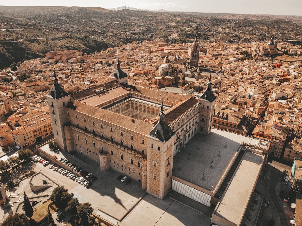 The Alcazar of Toledo fortress rising above the medieval city on a rocky hillside in Spain
