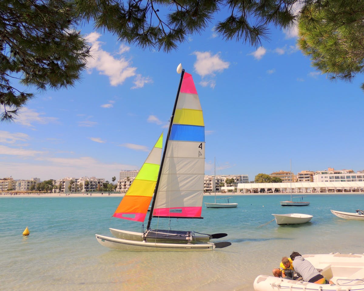 Catamaran sailing on clear blue water off the coast of Majorca