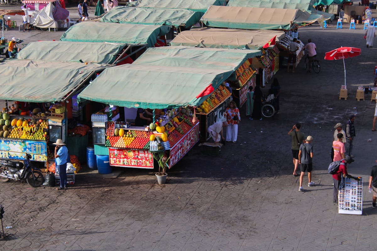 Colourful Moroccan souk stalls in Marrakech medina, packed with local goods and fabrics