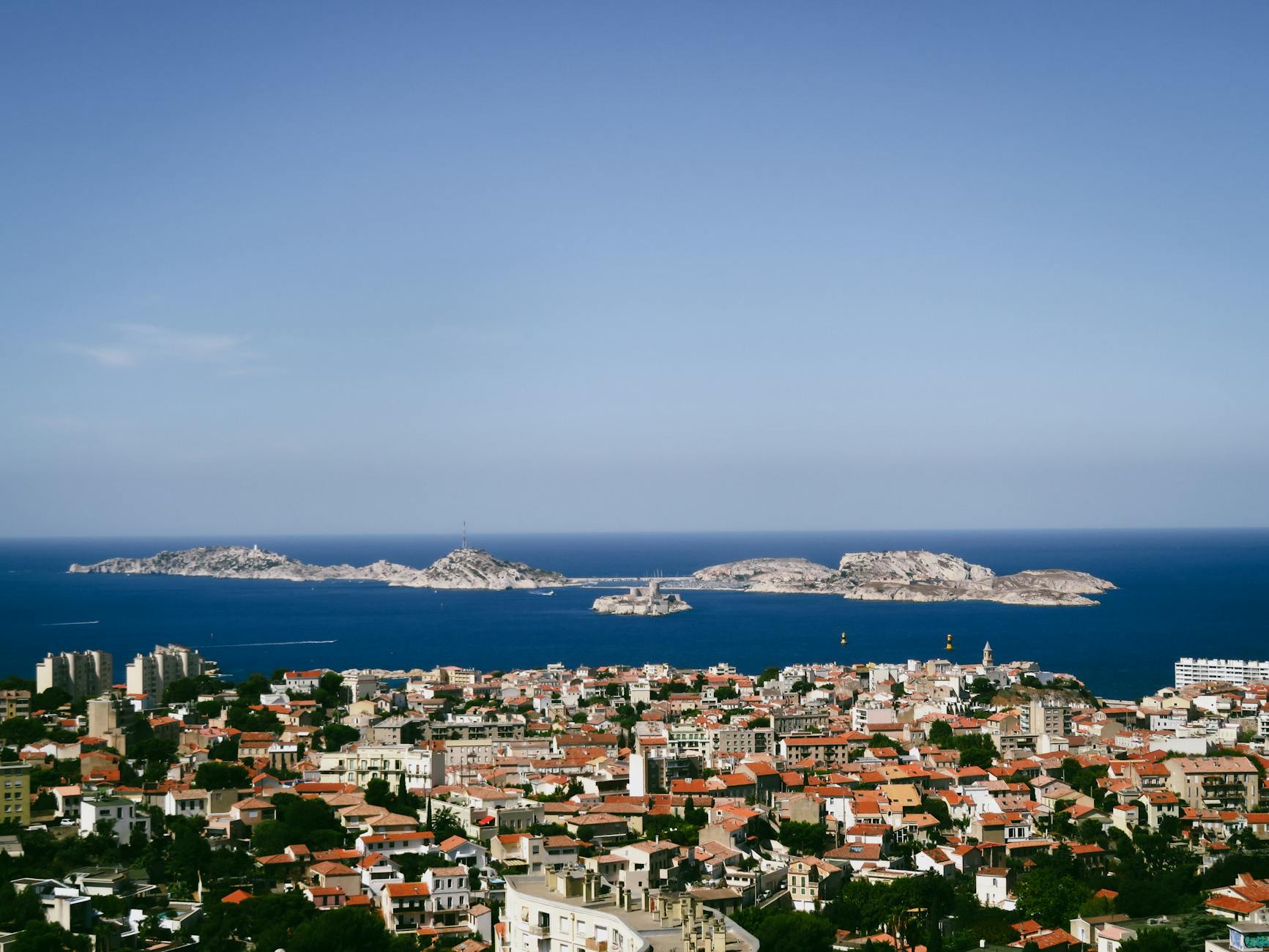 Aerial view of Marseille with the Frioul Archipelago and Mediterranean Sea beyond.