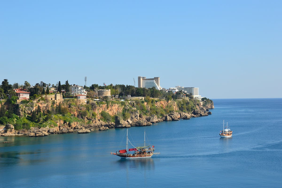 Coastal view of Antalya, Turkey, with turquoise sea and pine-covered limestone cliffs