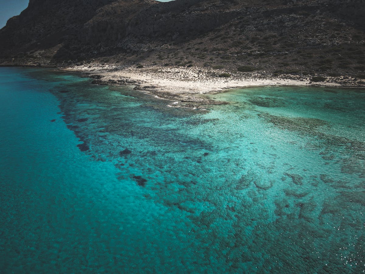 Tranquil turquoise bay with clear water and rocky coastline in Crete, Greece