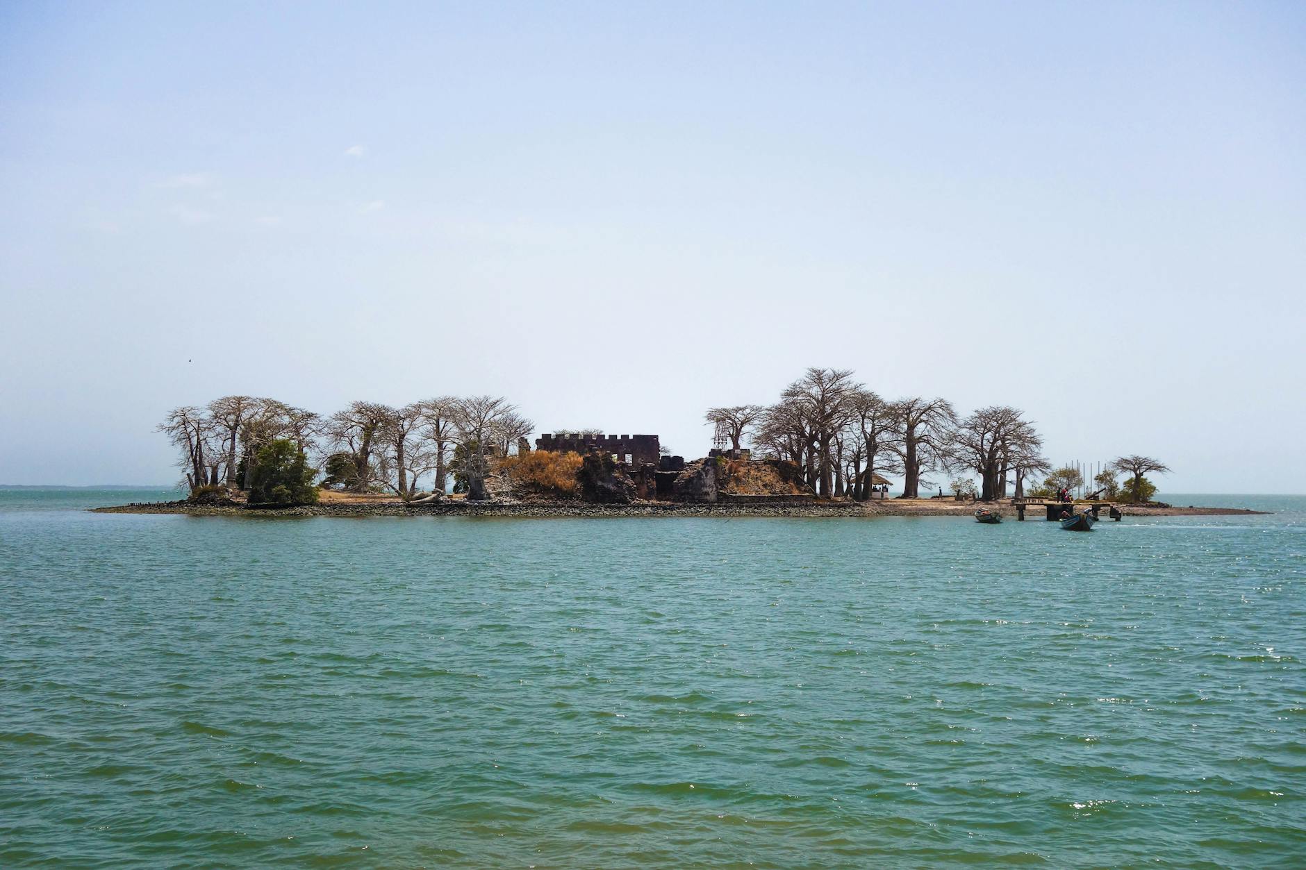 Remote island with historic ruins in The Gambia surrounded by ocean and trees