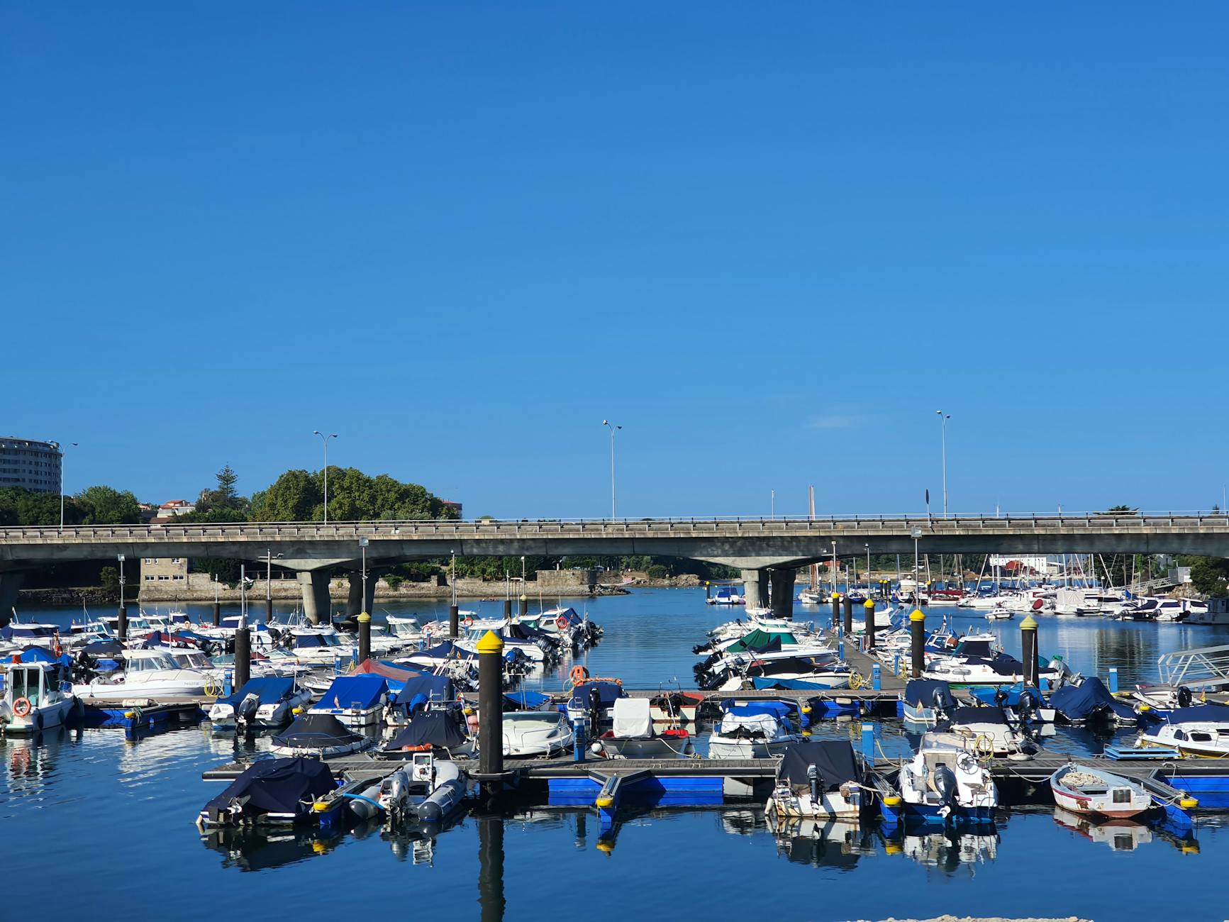 Boats docked in Vigo harbour on a bright sunny day in Galicia, Spain