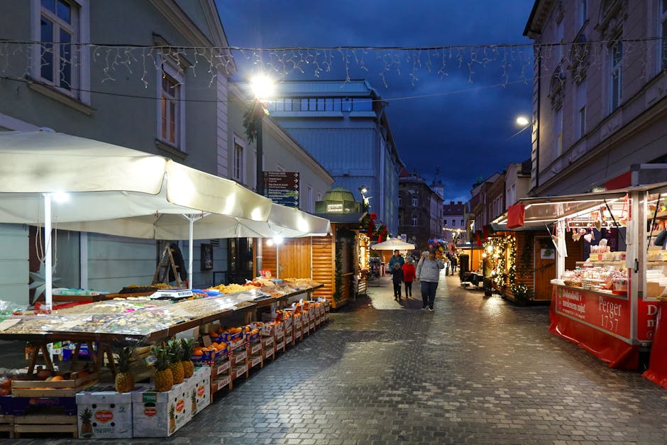 European street market at twilight with fresh produce stalls on cobblestones