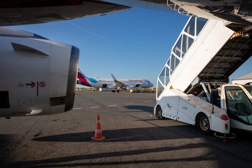 Budget airline aircraft on airport tarmac with jet bridge