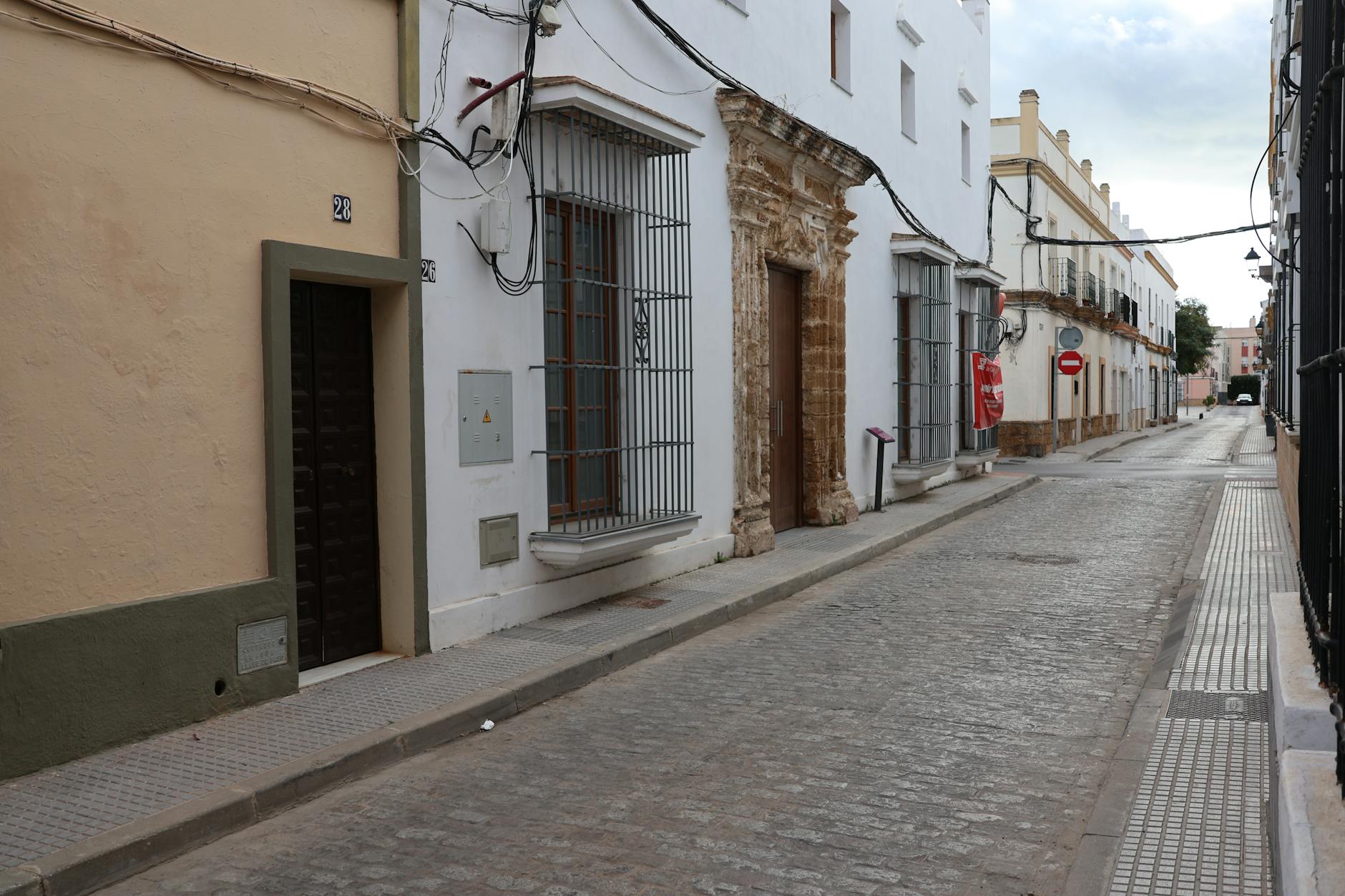 Narrow cobblestone street with historic stone buildings in an old town in Spain
