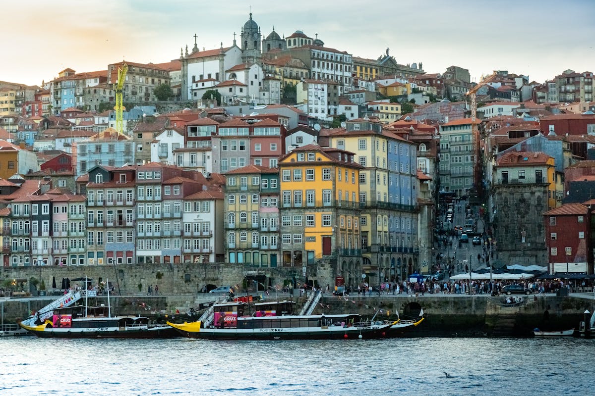 Porto Ribeira waterfront with colourful terraced buildings and boats on the River Douro