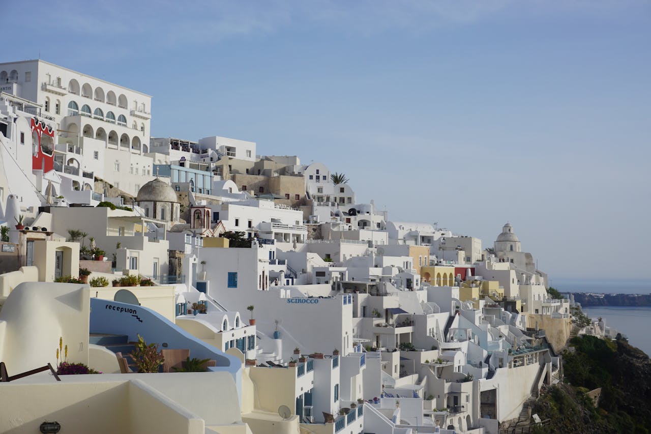 White-washed buildings and the blue Aegean Sea in Santorini, Greece, in summer