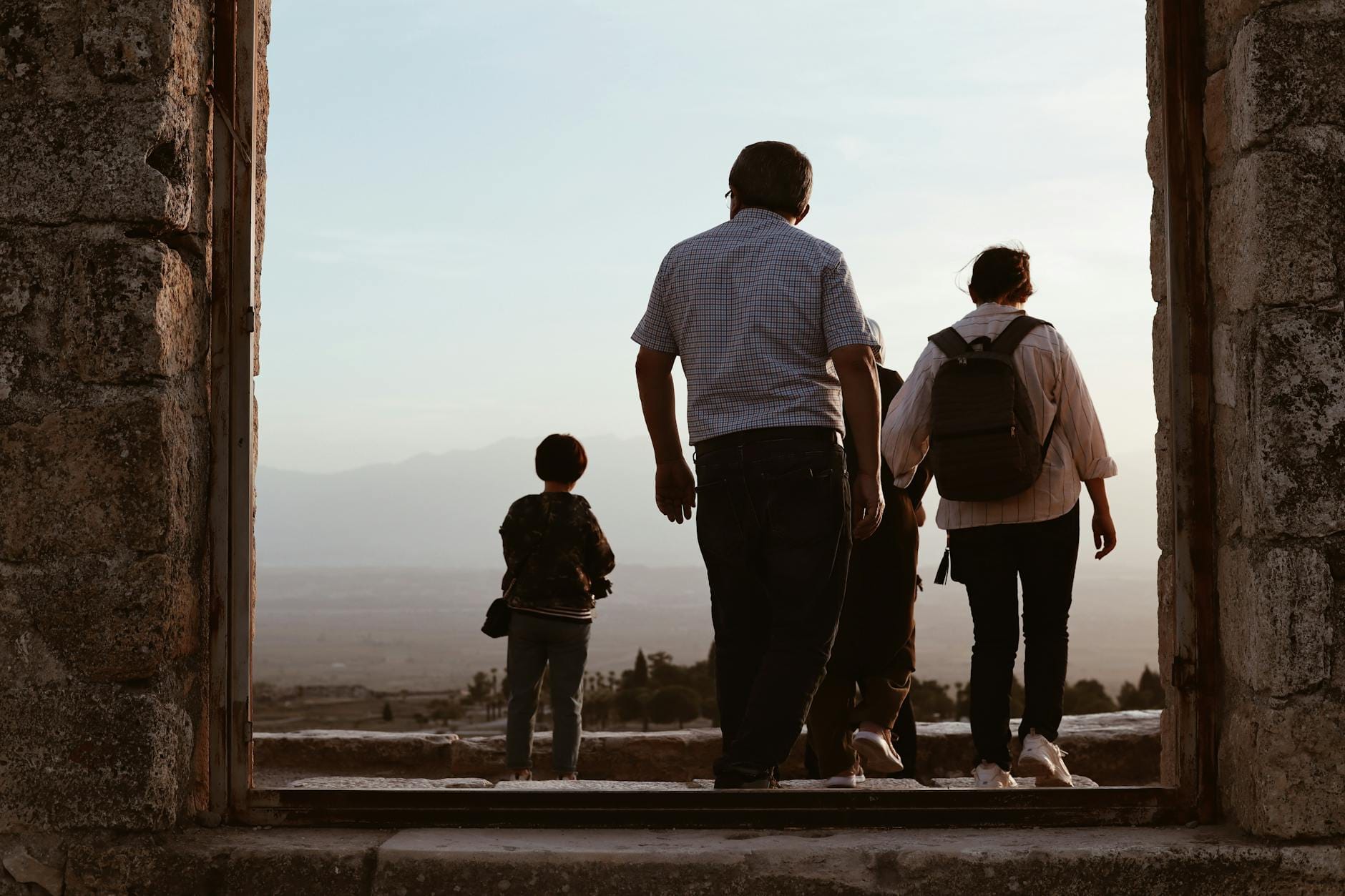 A family exploring ancient ruins on a school holiday abroad at sunset
