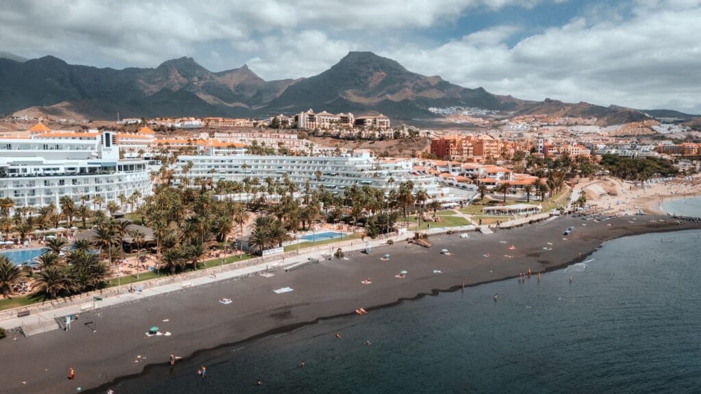 Aerial view of Adeje beachside resorts with mountains behind, Tenerife
