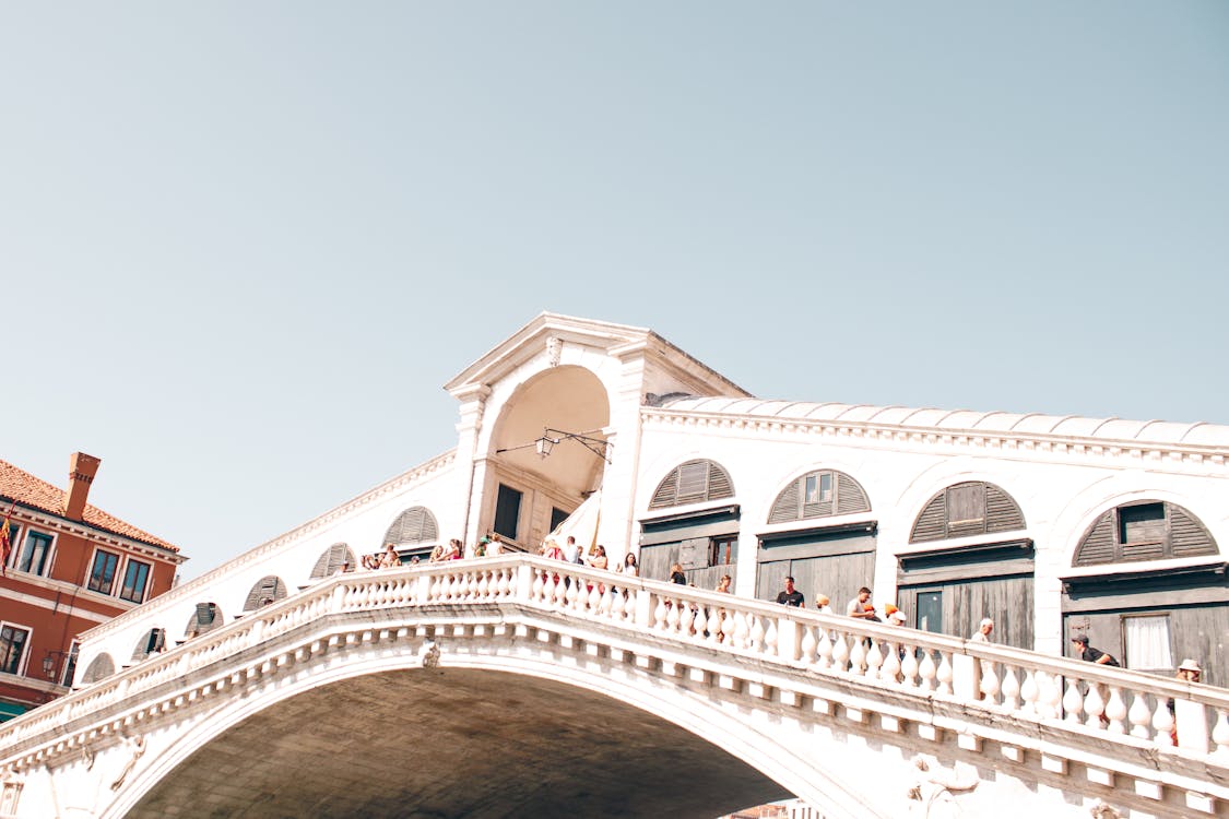 Scenic view of a Venice canal with a stone bridge and colourful historic buildings