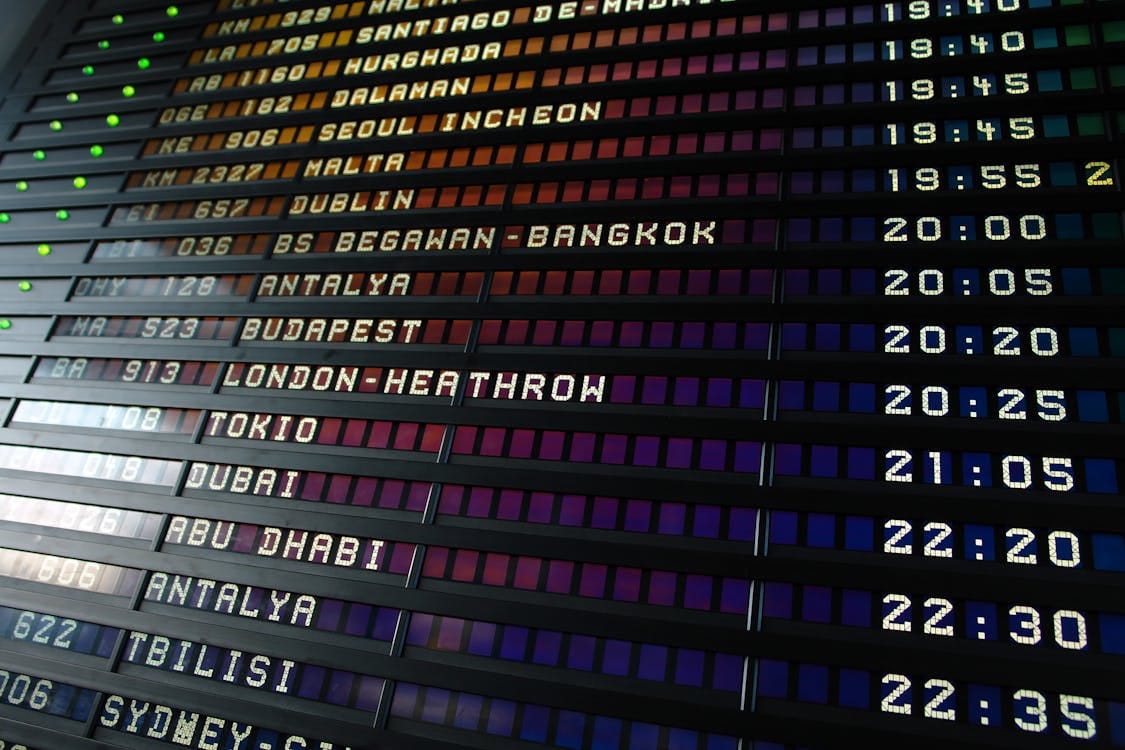 Retro flip-style airport departure board showing international destinations