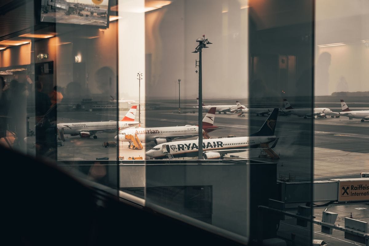 Multiple aircraft parked at a busy international airport terminal