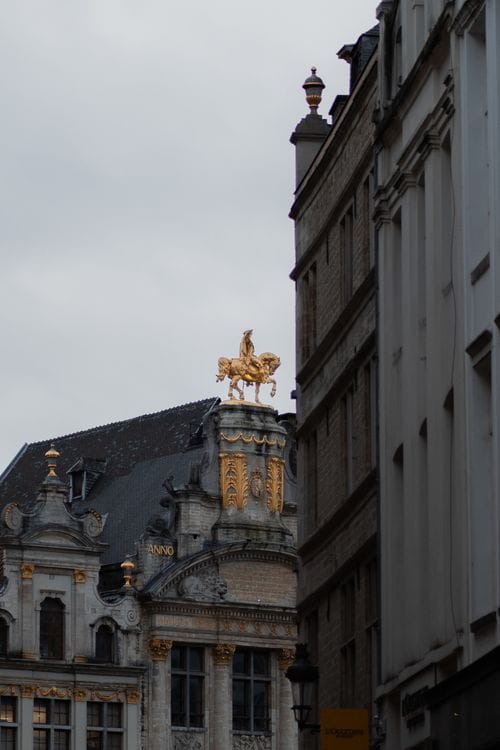 Gilded statue atop a guild house surrounding Grand Place in Brussels