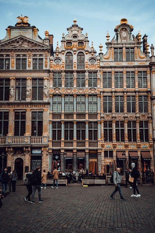 Visitors walk across Grand Place, Brussels' medieval city centre square