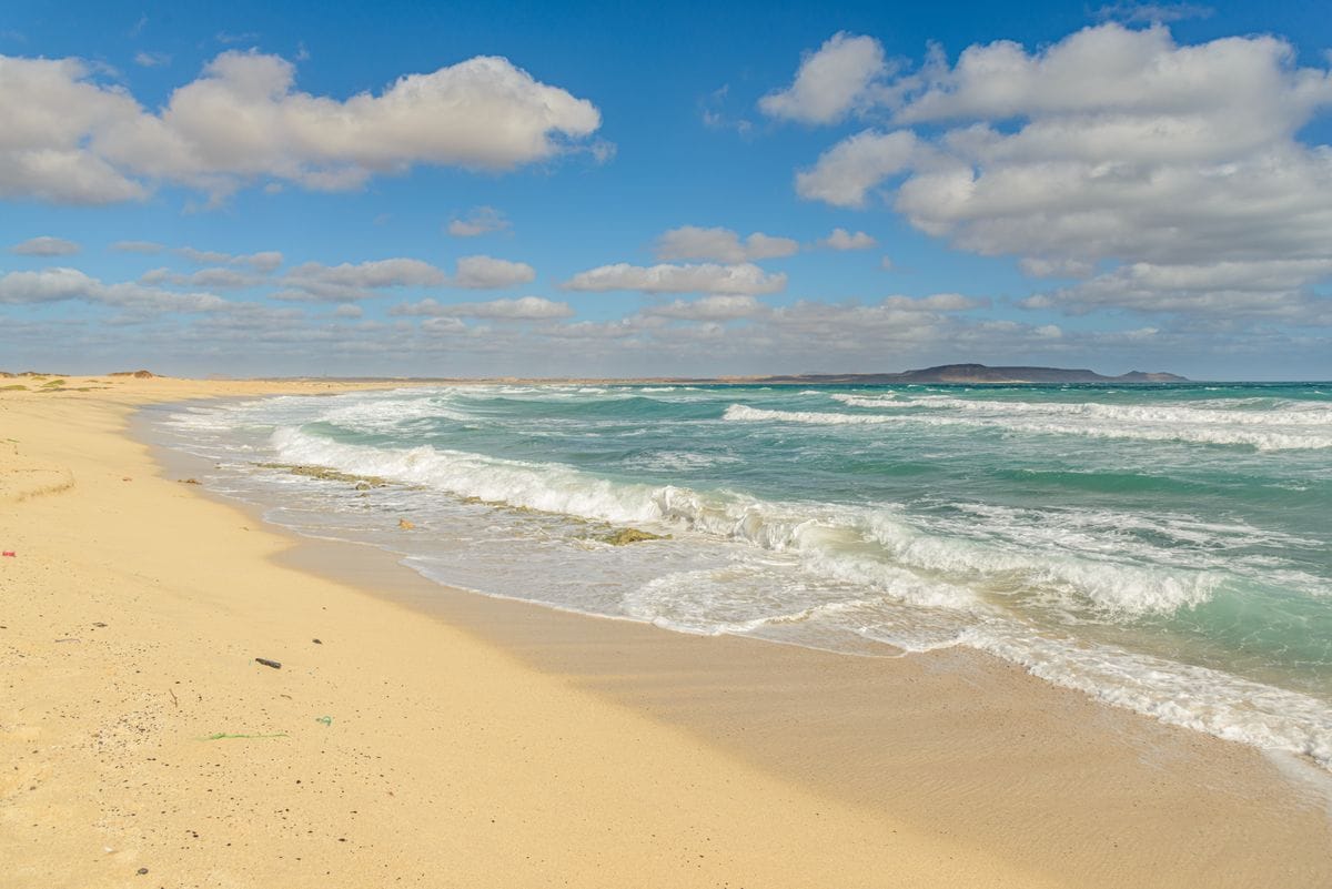 Wide sandy beach and turquoise sea in Cape Verde