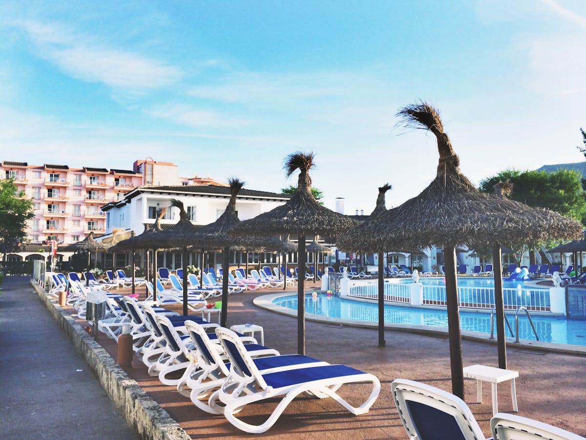 Sun loungers and straw parasols by a beach resort pool on Sal, Cape Verde