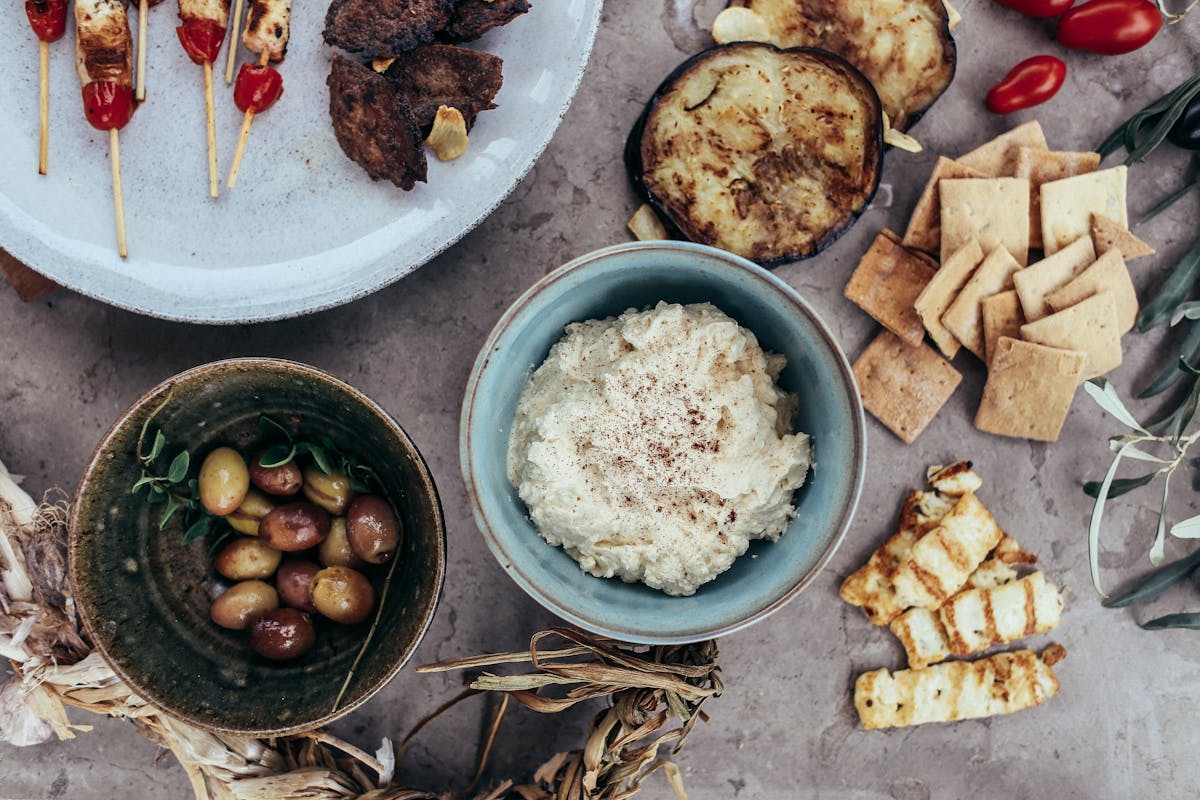 A Cypriot meze spread with grilled halloumi, olives, dip and skewers