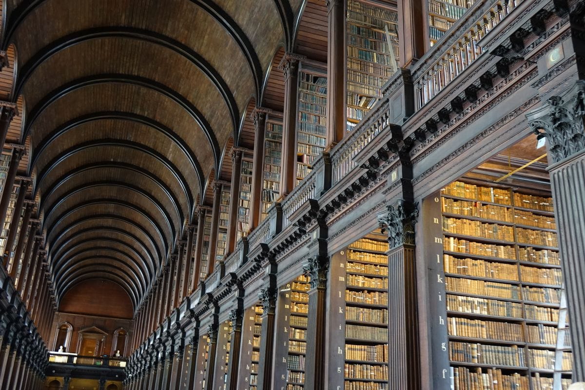 The Long Room library at Trinity College Dublin lined with old books and busts
