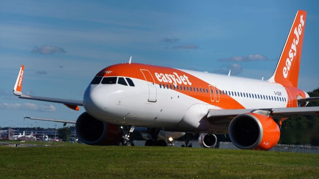 easyJet Airbus A320 aircraft on runway with orange and white livery and easyJet branding clearly visible