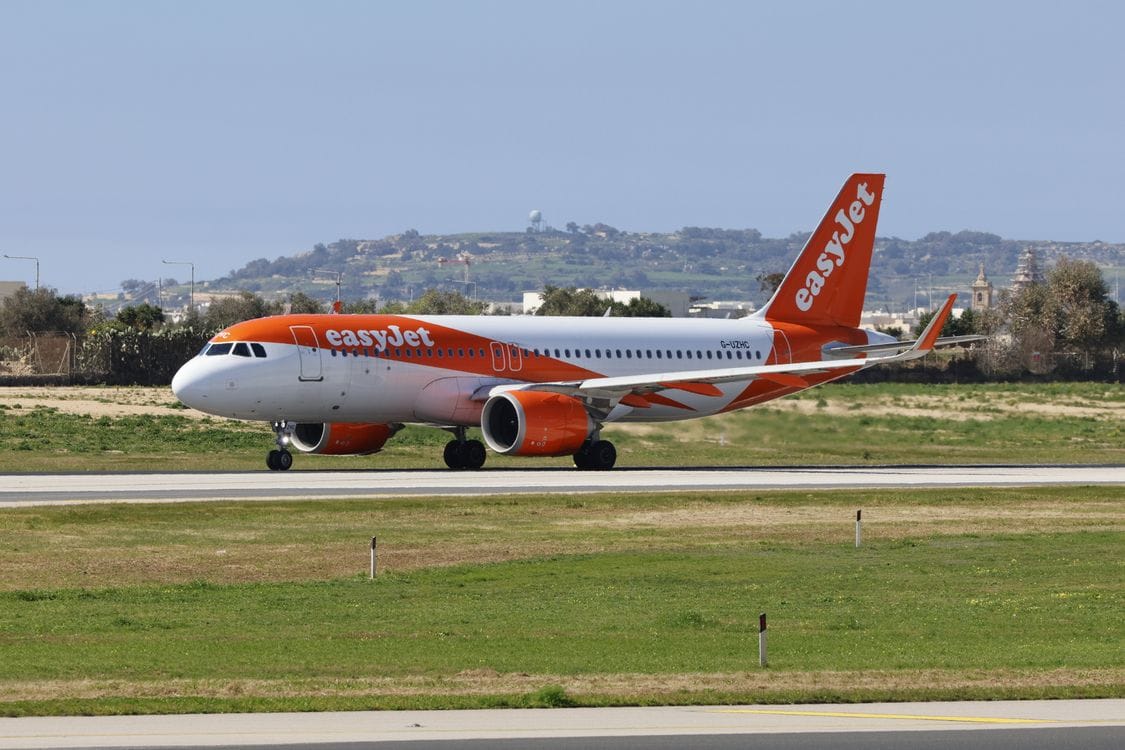 Passengers boarding an airplane at the departure gate