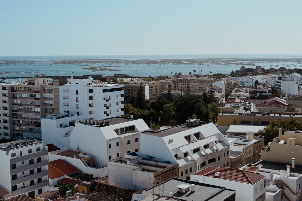 Faro city rooftops with a glimpse of the sea in the distance, Portugal